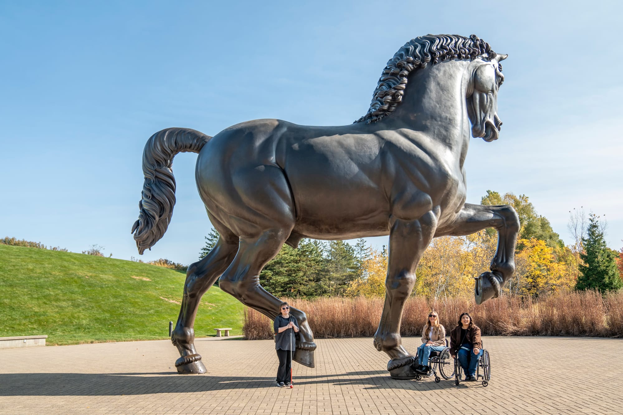 Two wheelchair users and blind person at Frederik Meijer Gardens & Sculpture Park