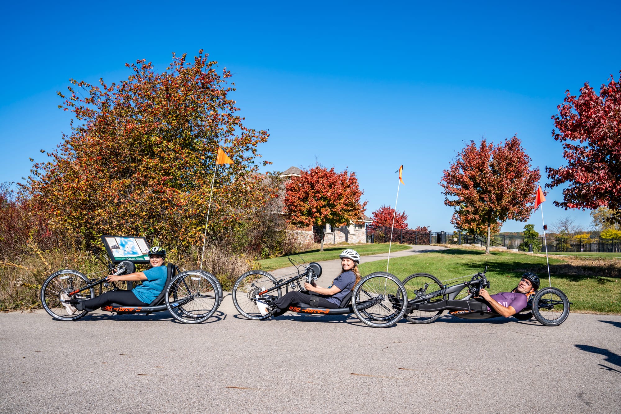 Disabled people enjoying adaptive cycling at Millennium Park in Grand Rapids