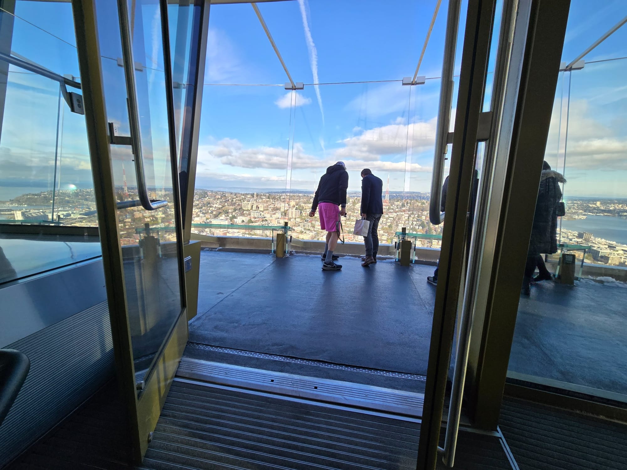 People looking at the city from top of the Space Needle in Seattle