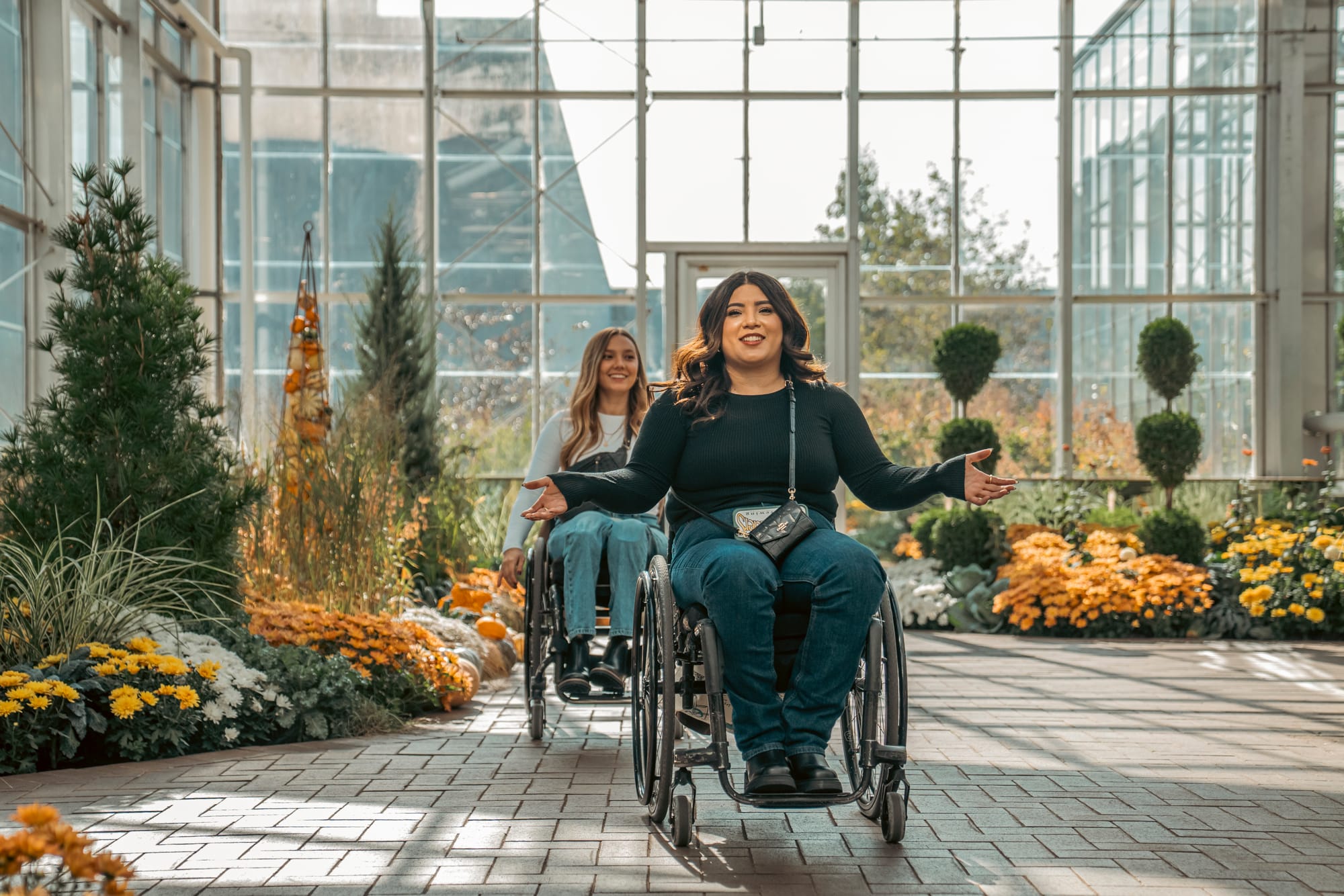 Two wheelchair users at Frederik Meijer Gardens & Sculpture Park in Grand Rapids