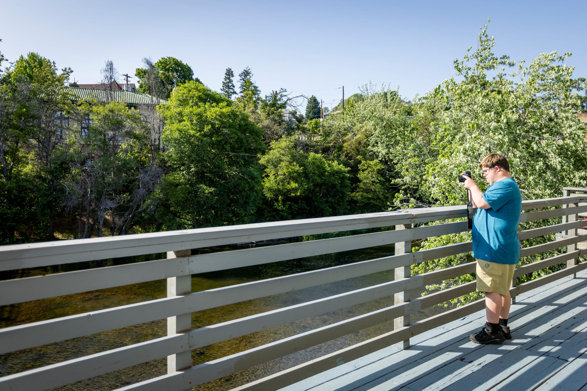 Houston, a man with down syndrome, walking and taking pictures along the Pendleton Riverwalk