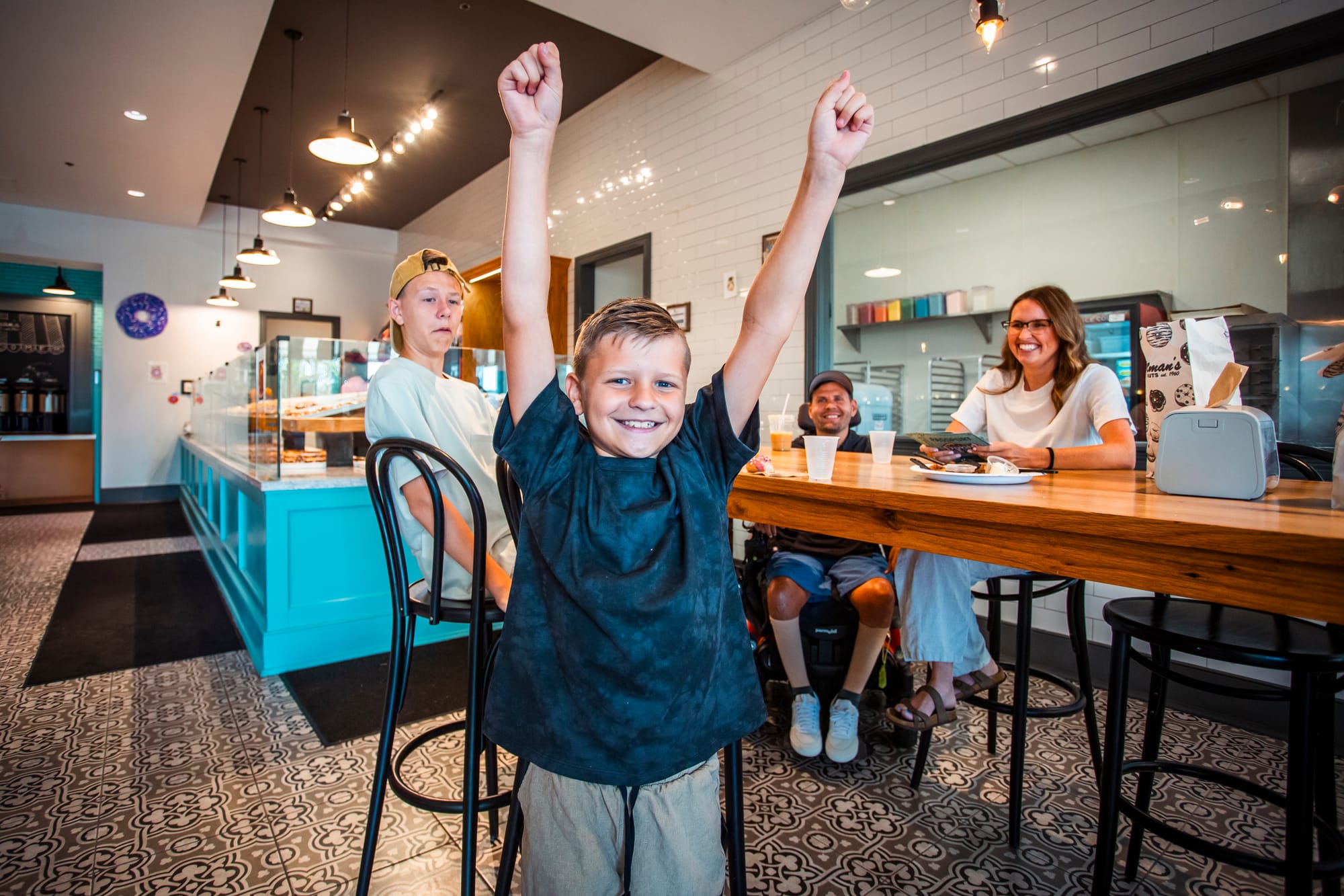 Excited boy in a donut shop on the Donut Trail, Butler County
