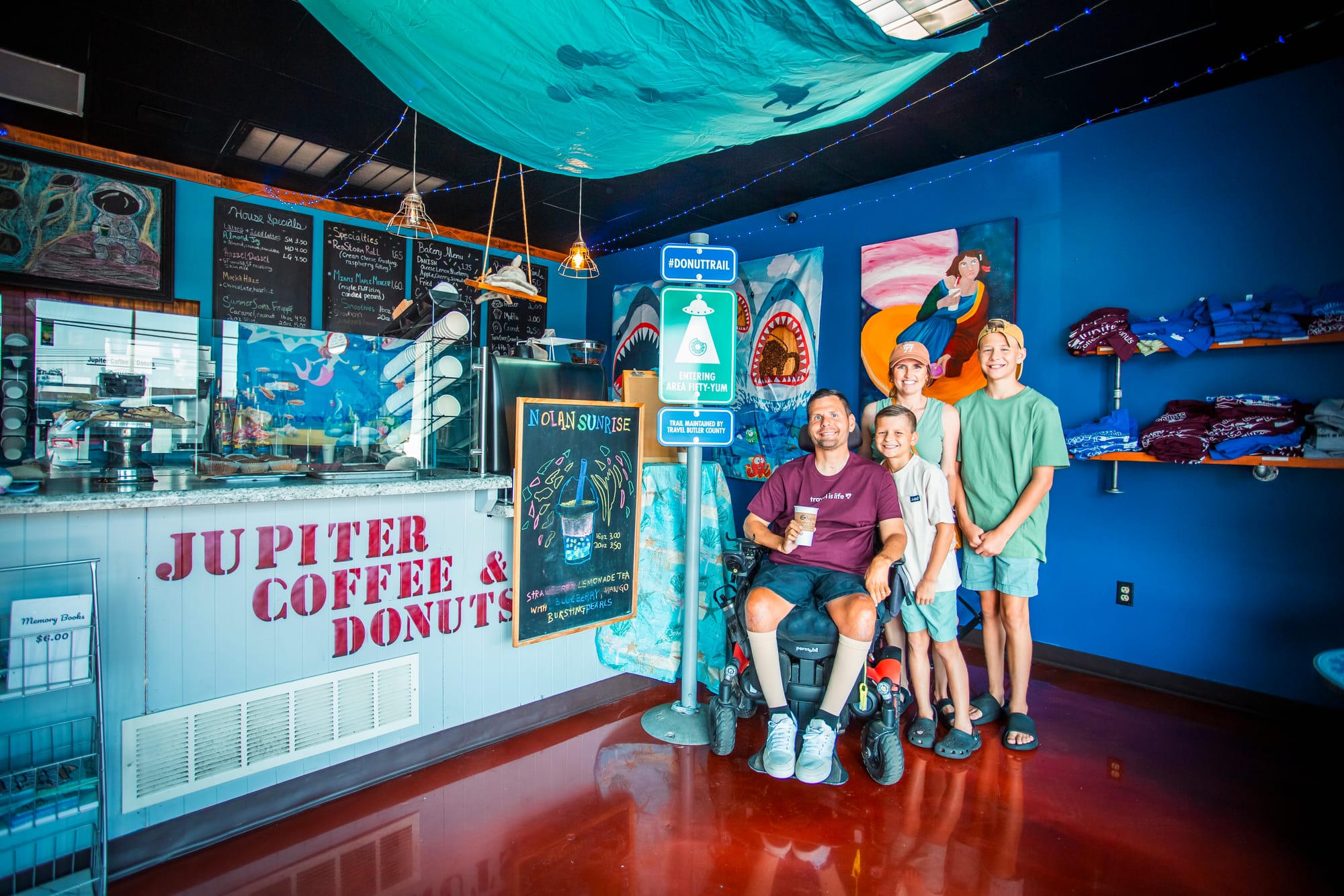 Wheelchair user and family inside of Jupiter Coffee & Donuts