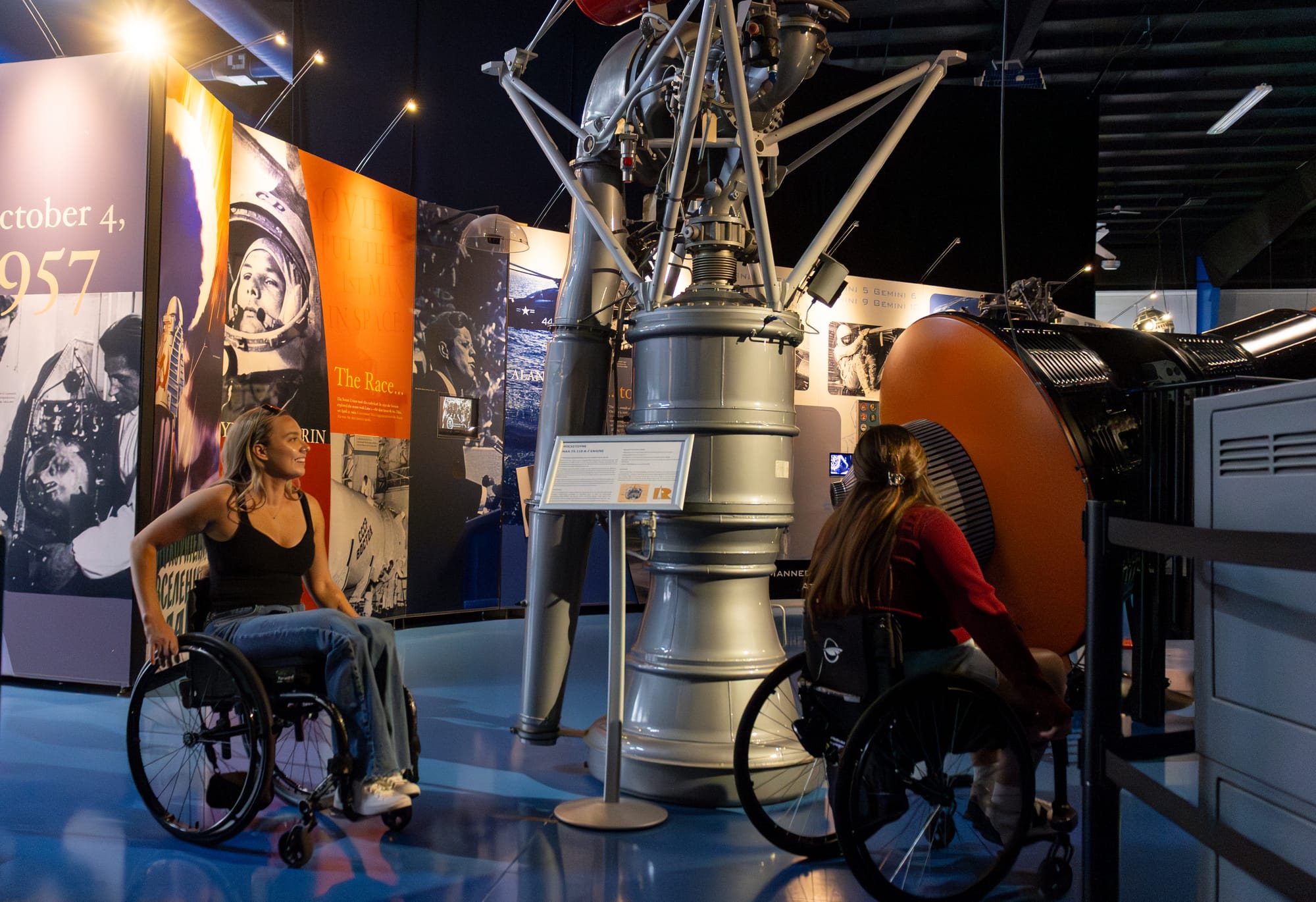 Wheelchair users viewing exhibits at Air Zoo Aerospace & Science Museum