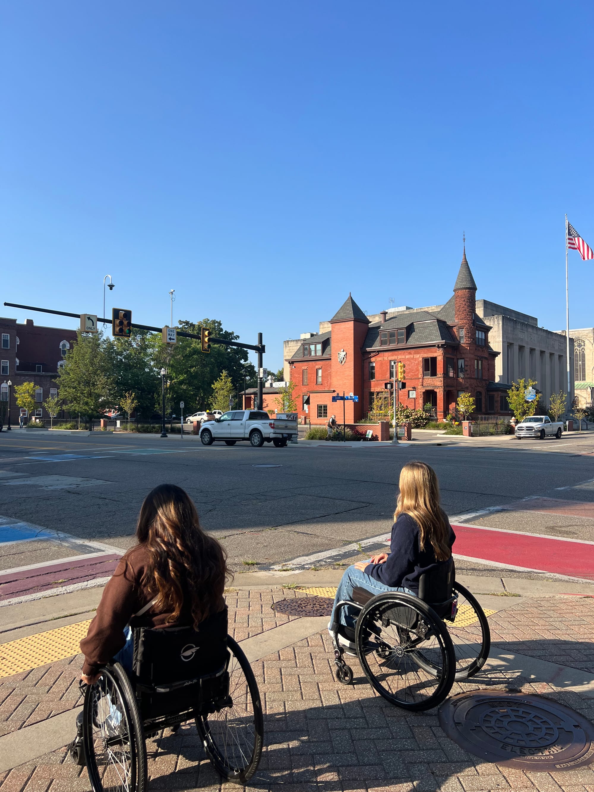 Two wheelchair users exploring the streets in Kalamazoo