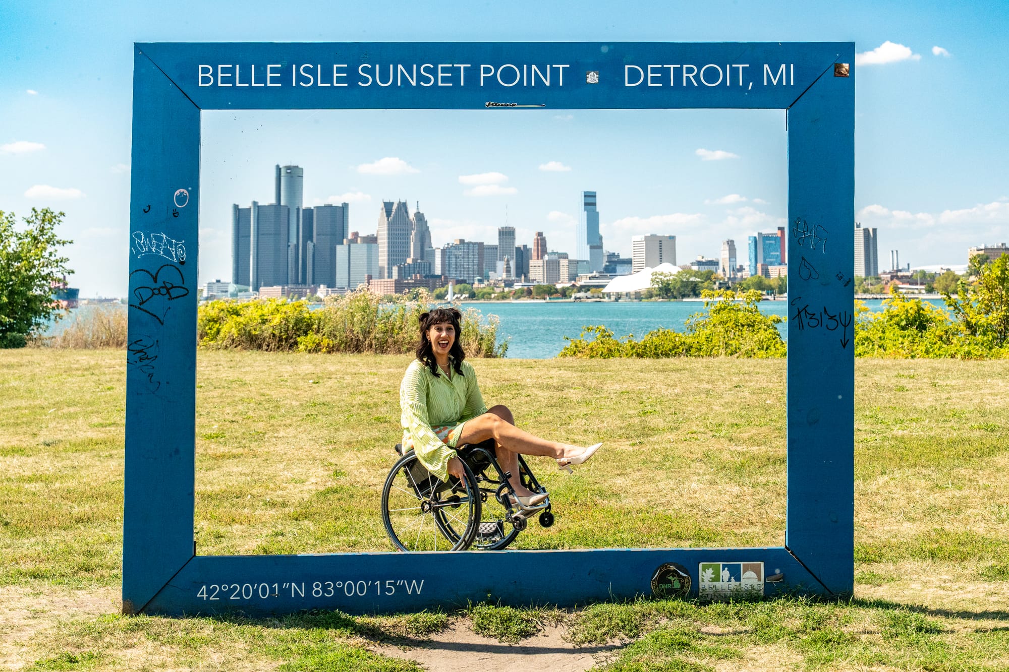 Kaylee Bays in front of the Belle's Isle Sunset Point sign