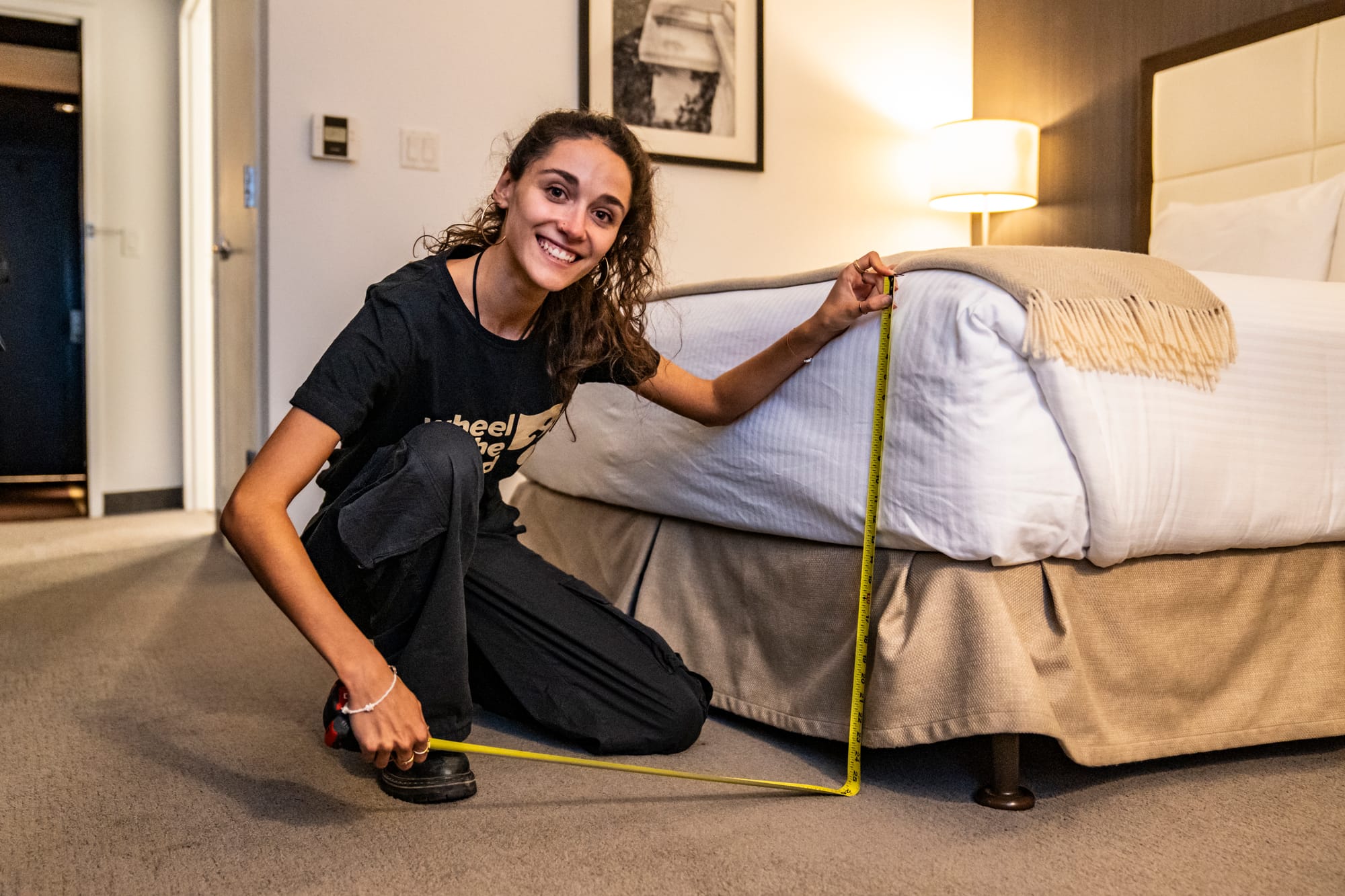 Woman taking hotel measurements for detailed, verified accessibility information for travelers