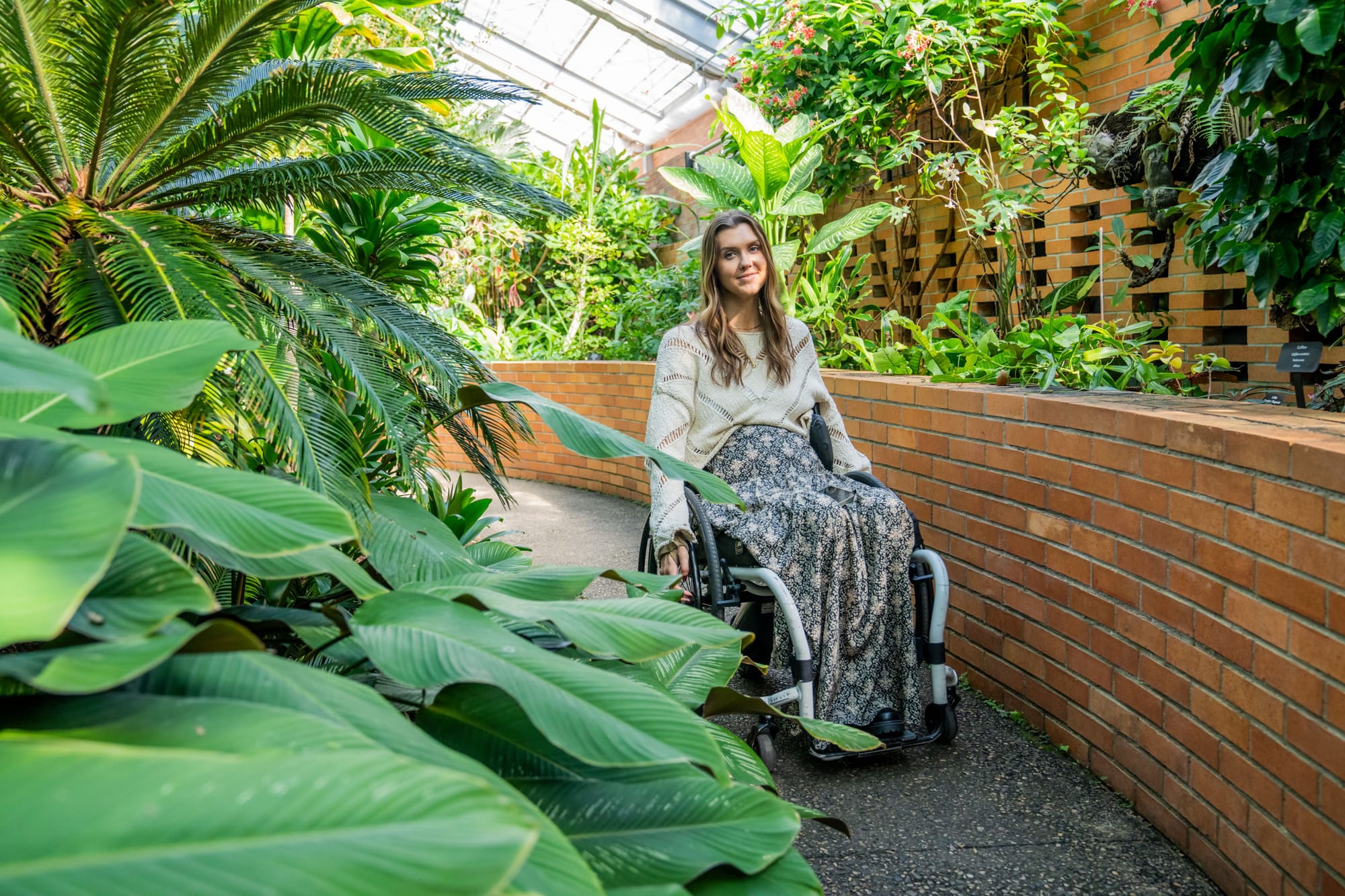 Wheelchair user rolling through Michigan Matthaei Botanical Gardens