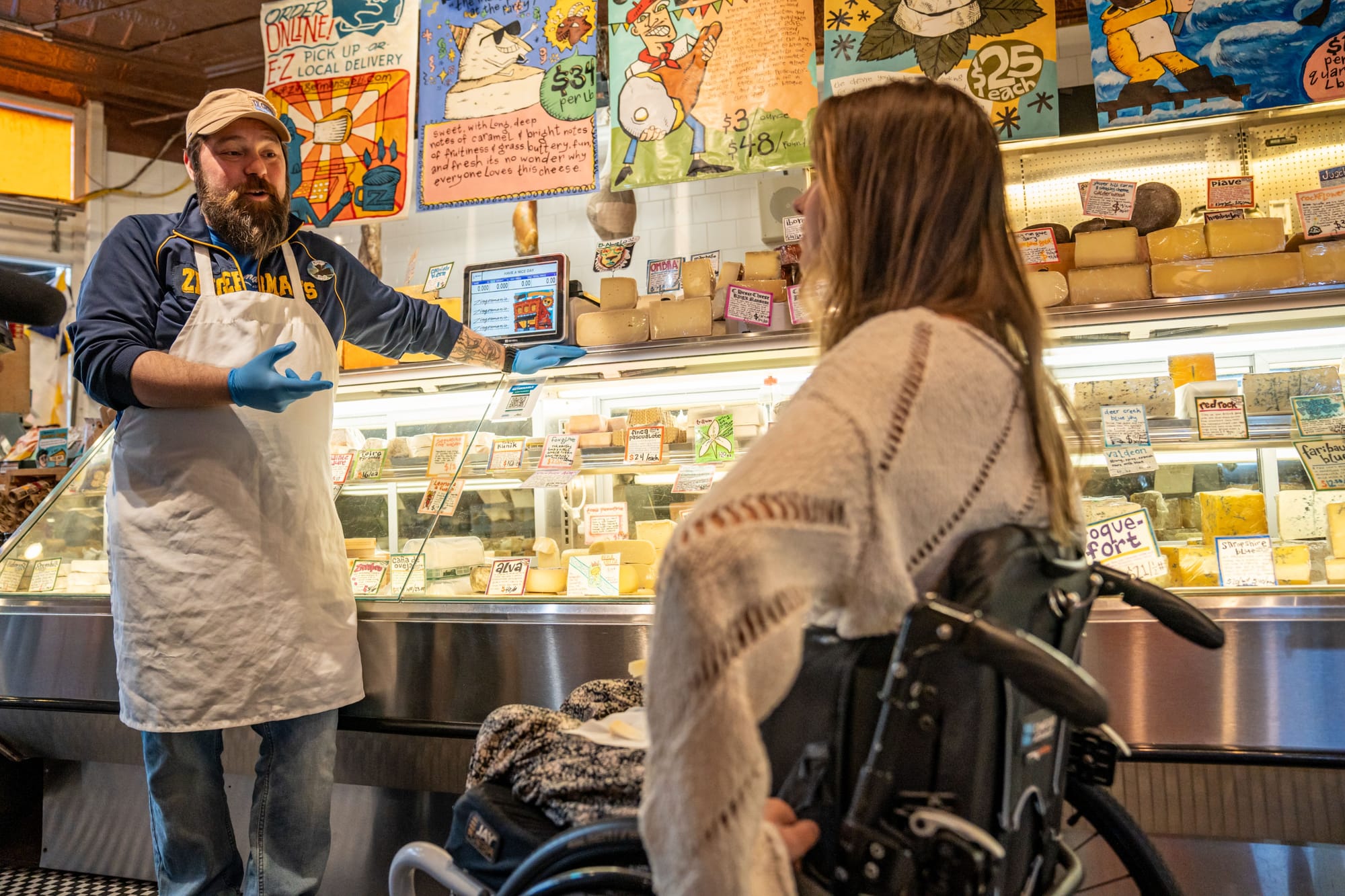 Wheelchair user talking to employee at Zingerman's Delicatessen in Ann Arbor