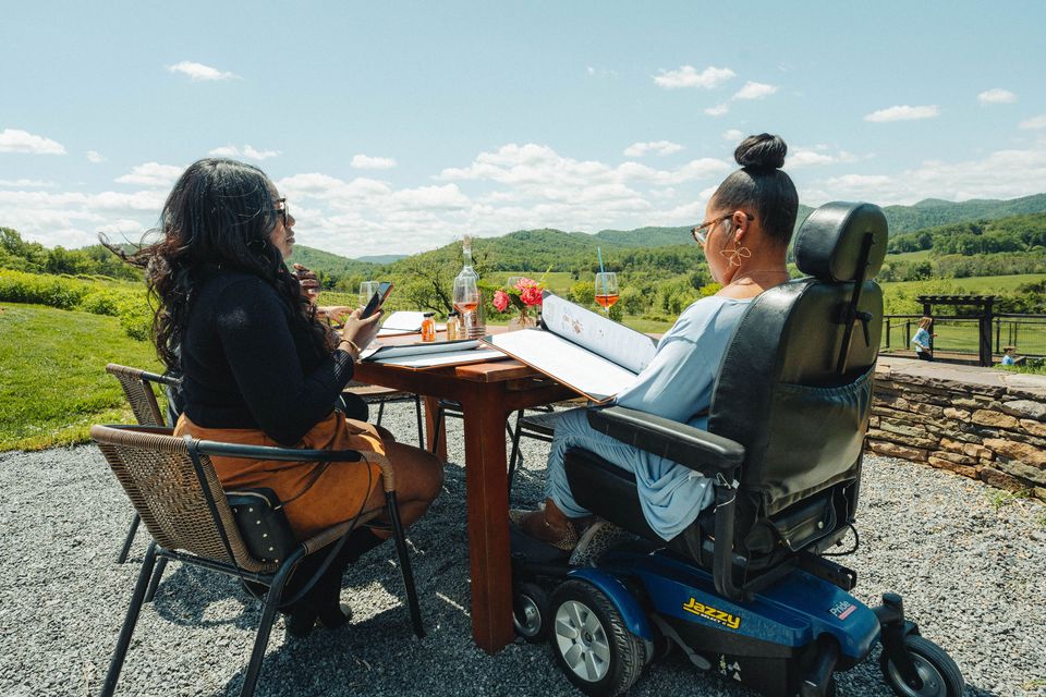 Wheelchair user enjoying wine at a beautiful winery in Charlottesville, VA