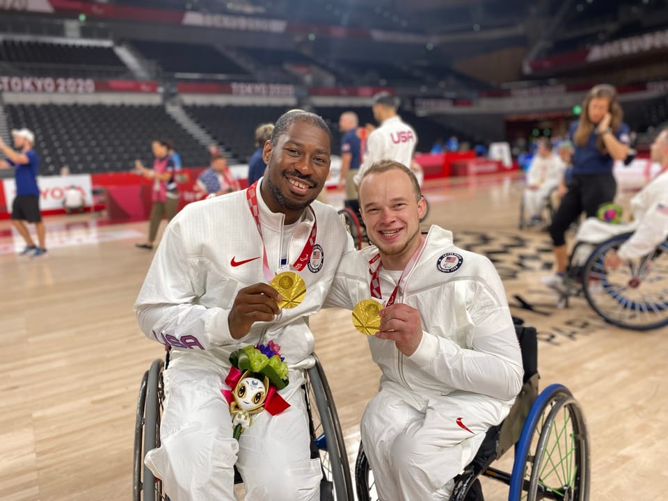 John Boie and his teammate with their gold medals at the 2020 Paralympic Games for wheelchair basketball