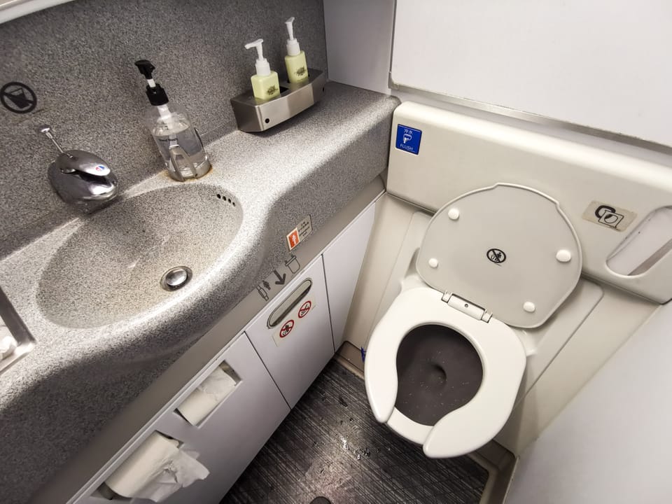 Airplane lavatory with toilet and sink