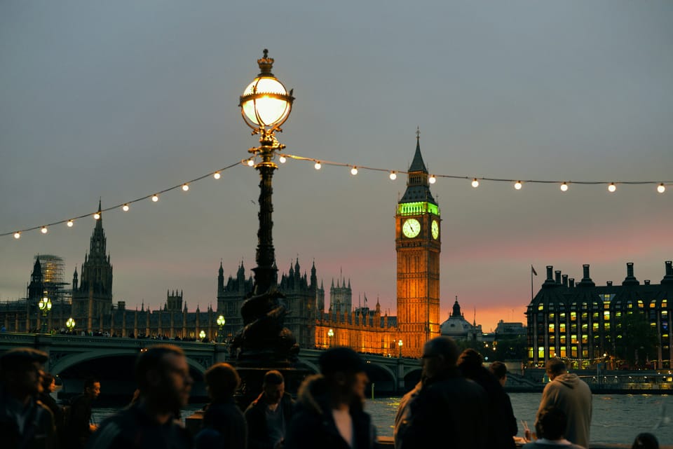 Big Big clock tower lit up at night in London, England