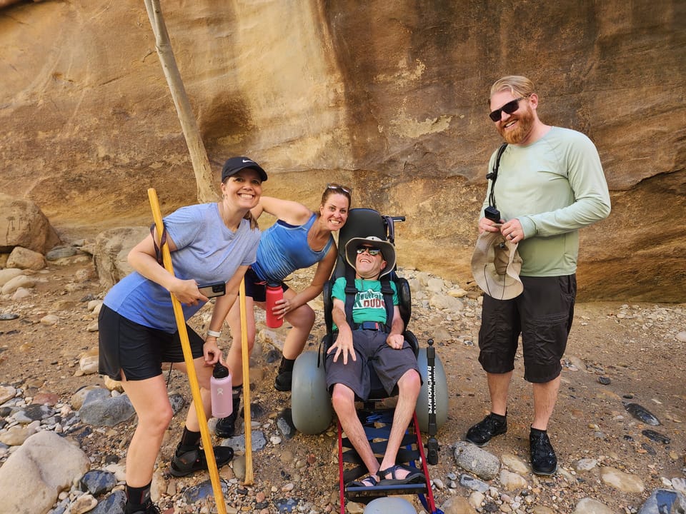 Wheelchair-user and friends on an accessible hike in Zion National Park