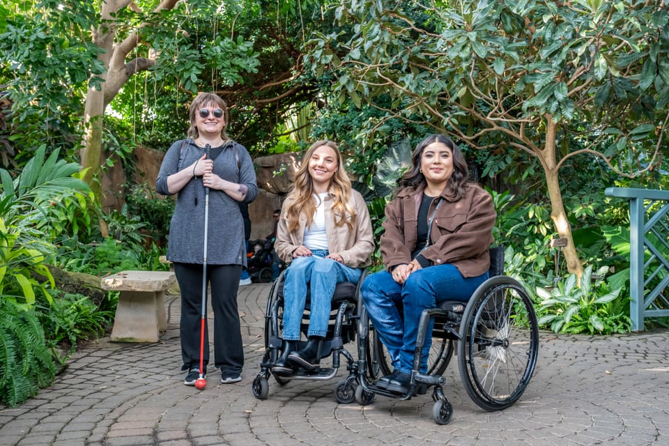 Two wheelchair-users and blind person exploring Grand Rapids