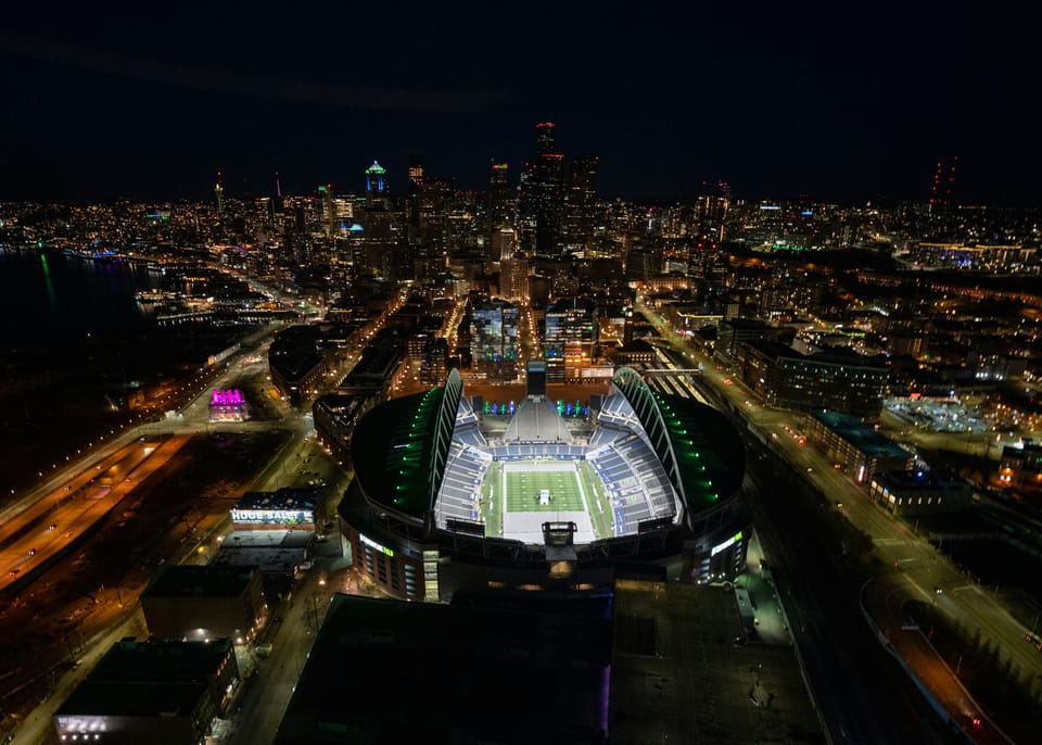 Lumen Field lit up in Seattle at night