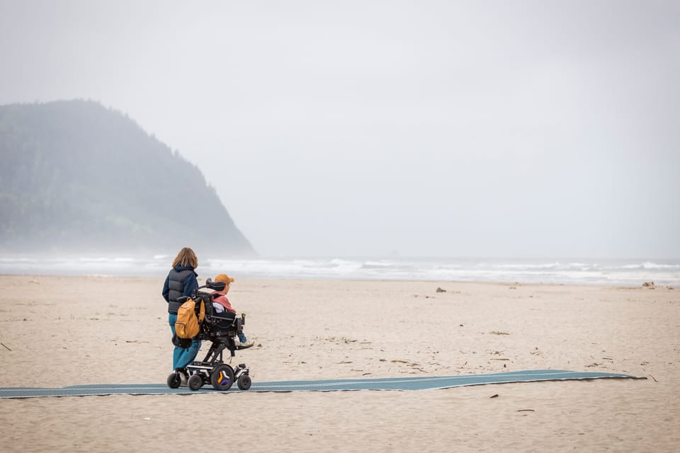 Shane Burcaw and his wife, Hannah, on mobi-mats in Seaside, Oregon