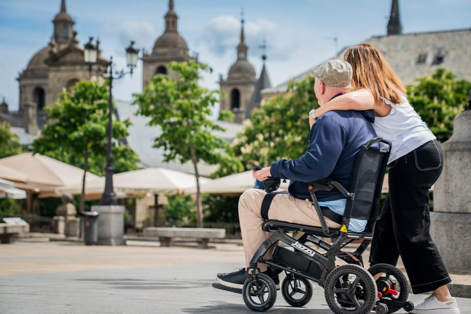 Man in travel power wheelchair with his wife in Madrid