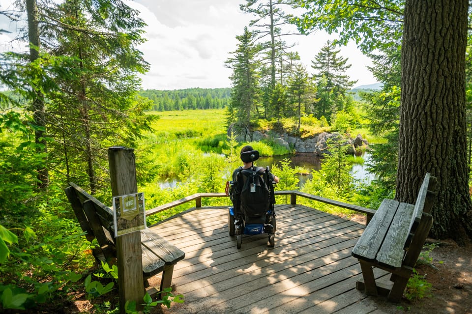 Curb Free With Cory Lee, wheelchair user, at an overlook at Paul Smith’s Visitor Interpretive Center (VIC)
